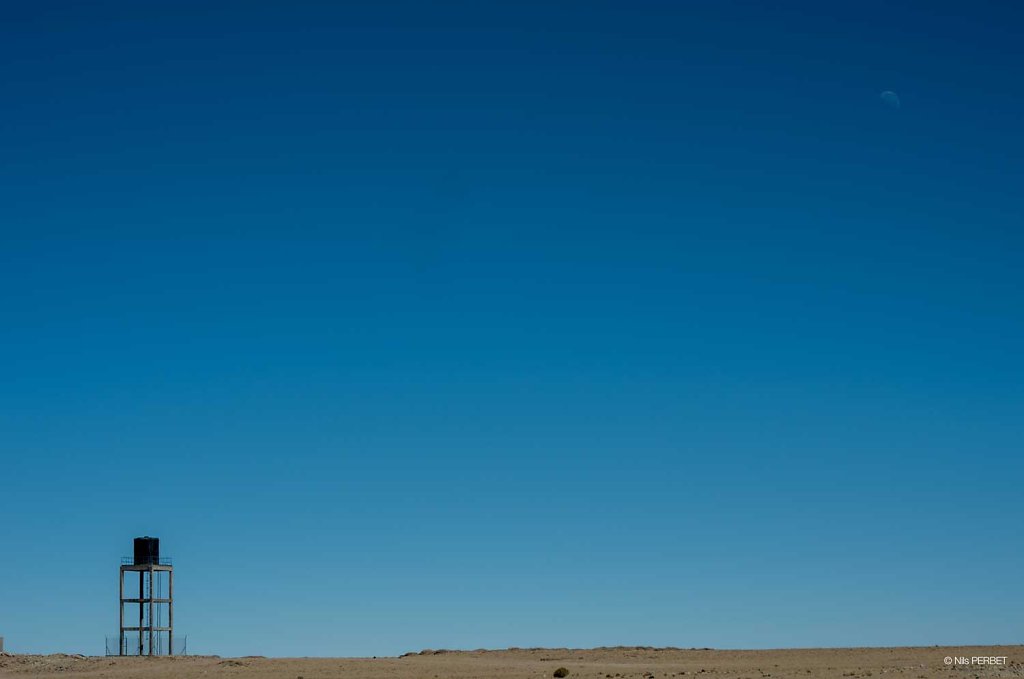 Water Tower and the Moon in the Salar de Uyuni